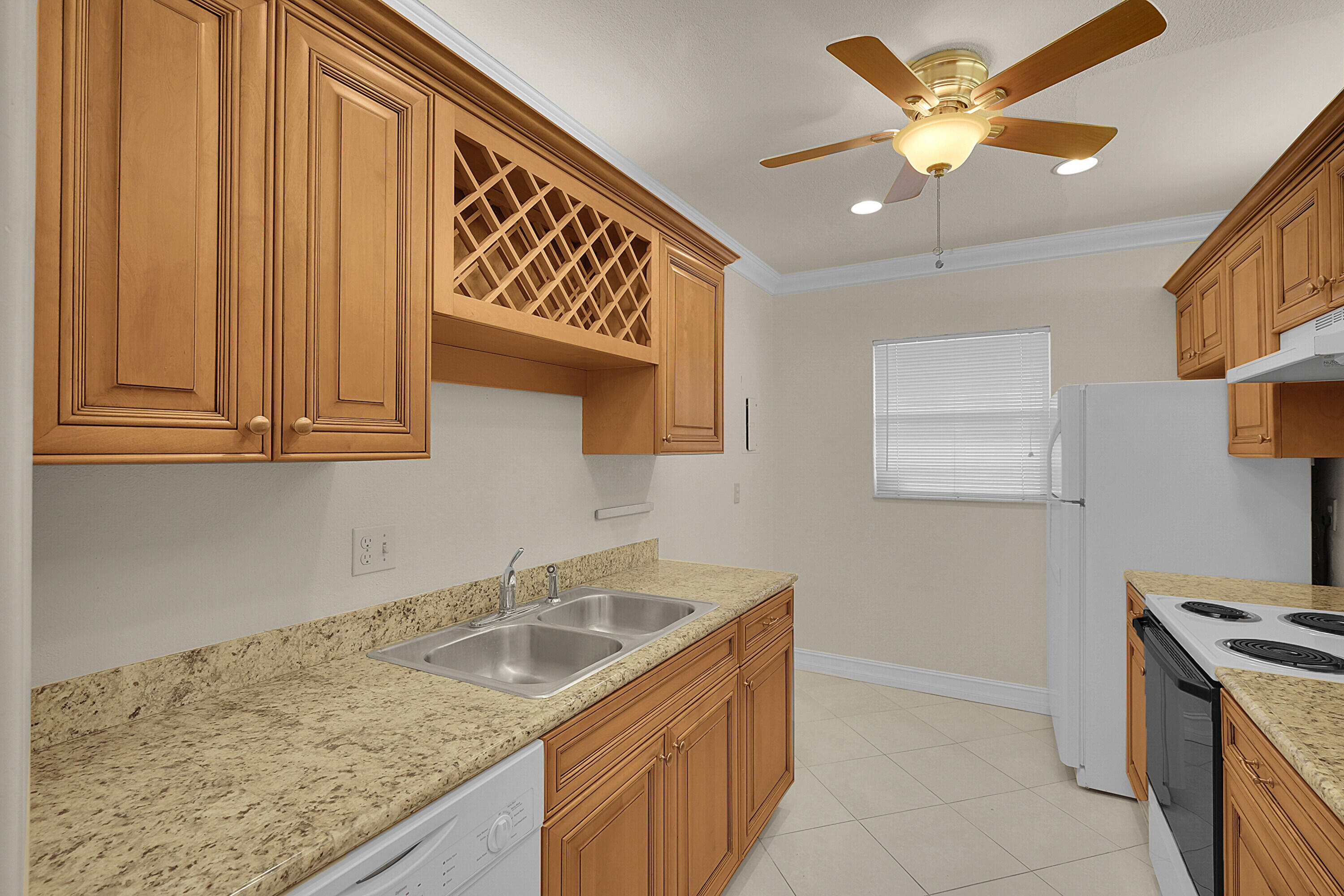 2340 Southwest 22nd Avenue, Unit 306 Delray Beach, FL 33445 - Photo 13 of 33 a kitchen with stainless steel appliances granite countertop a sink and cabinets
