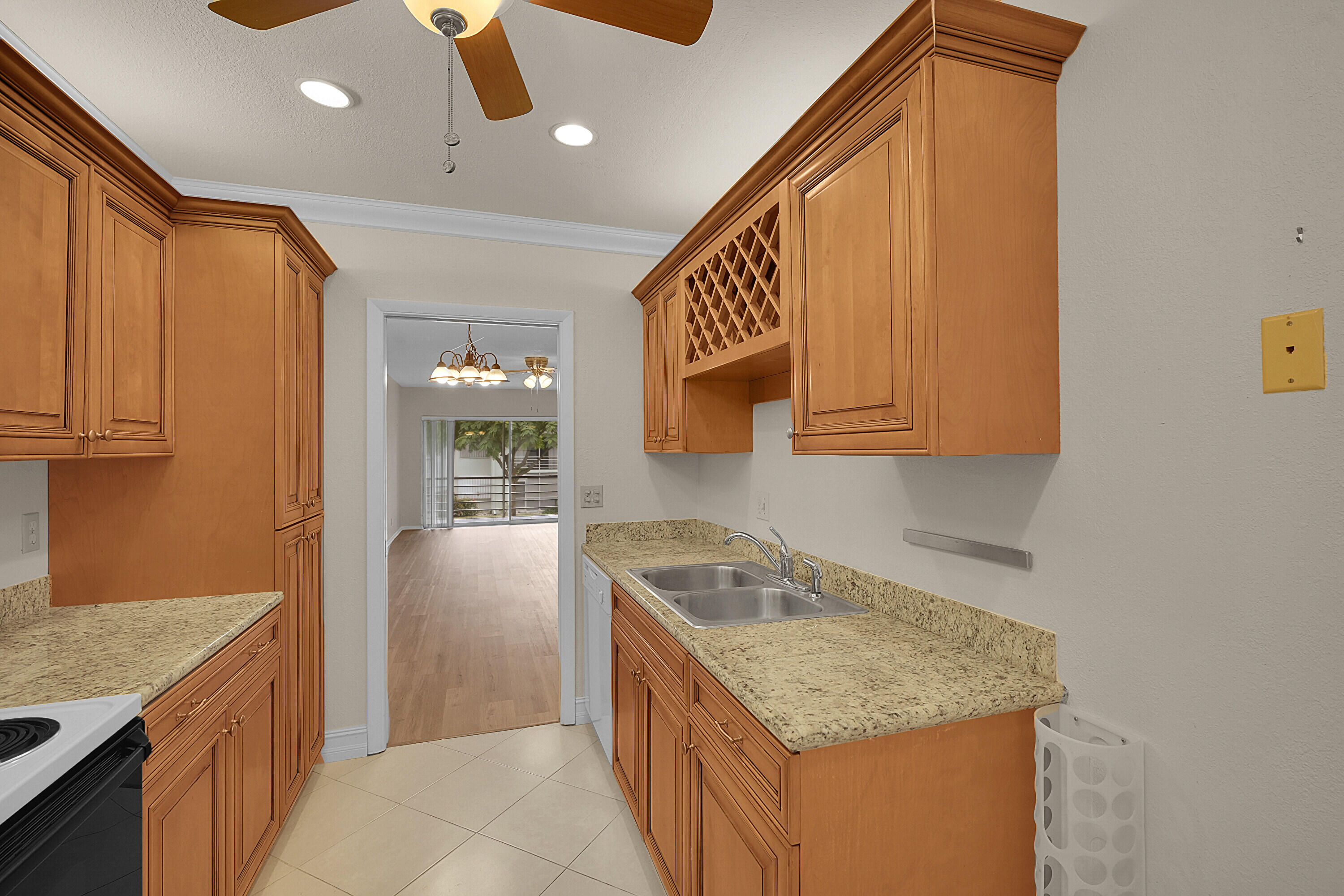 2340 Southwest 22nd Avenue, Unit 306 Delray Beach, FL 33445 - Photo 14 of 33 a kitchen that has a sink and a stove in it