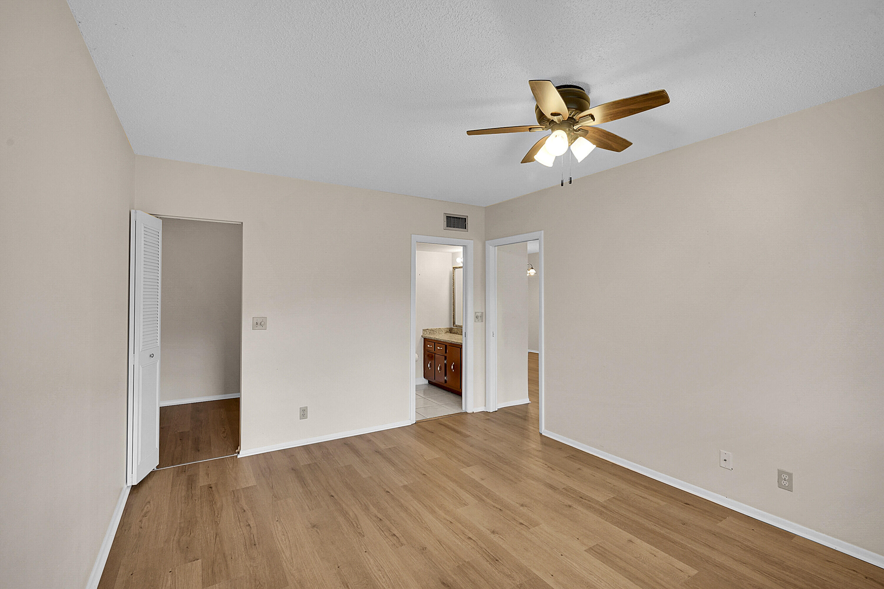 2340 Southwest 22nd Avenue, Unit 306 Delray Beach, FL 33445 - Photo 18 of 33 a view of empty room with wooden floor