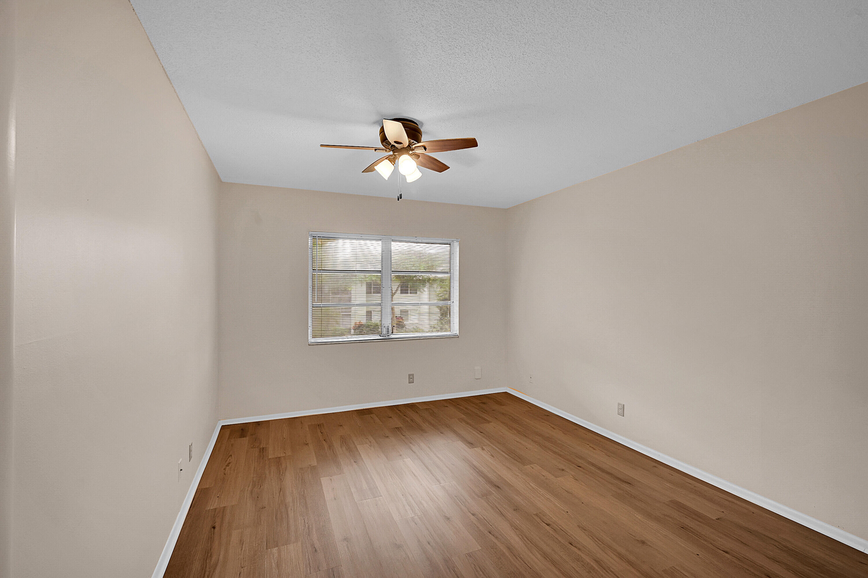 2340 Southwest 22nd Avenue, Unit 306 Delray Beach, FL 33445 - Photo 20 of 33 wooden floor in an empty room with a window