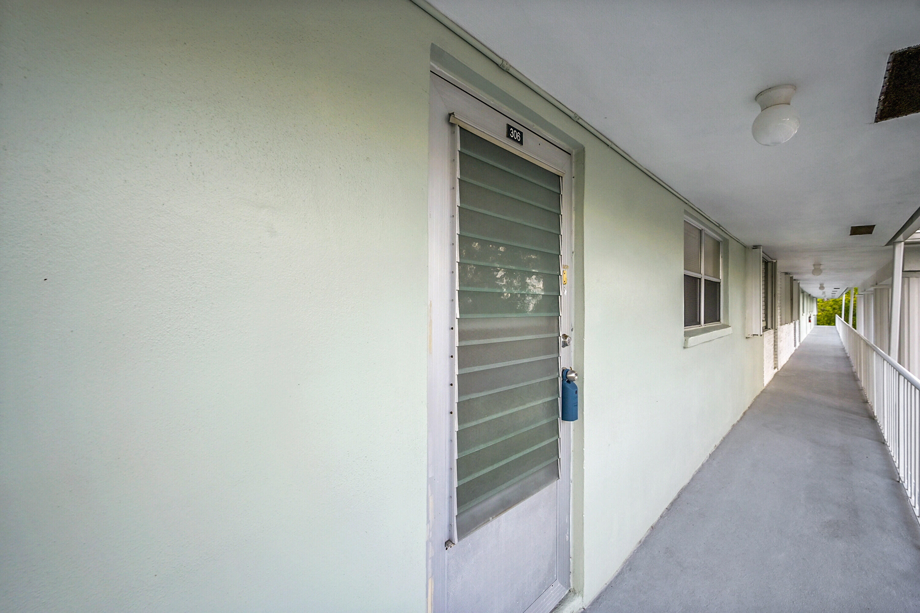 2340 Southwest 22nd Avenue, Unit 306 Delray Beach, FL 33445 - Photo 2 of 33 a view of a hallway with wooden cabinets and entryway