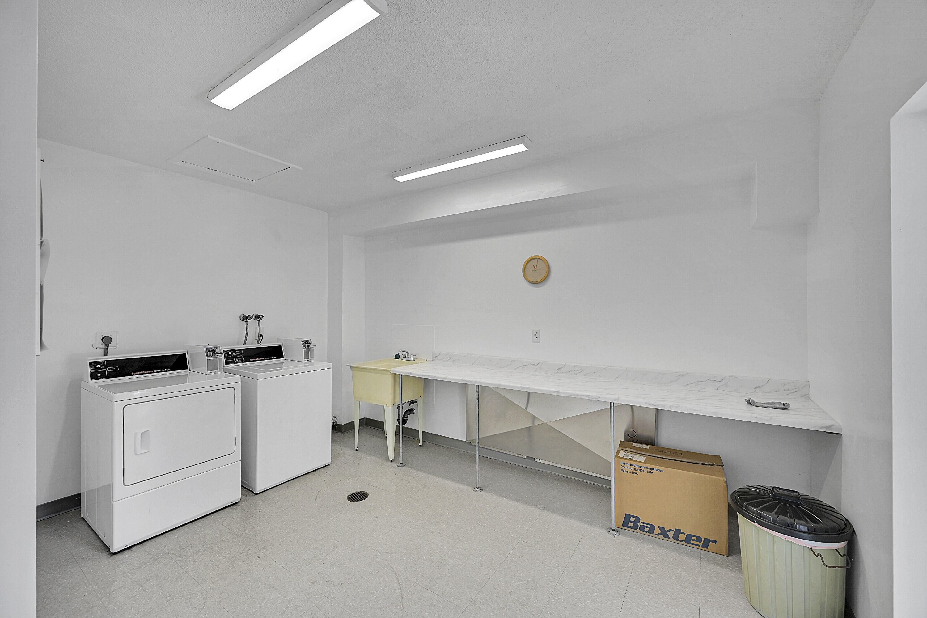 2340 Southwest 22nd Avenue, Unit 306 Delray Beach, FL 33445 - Photo 28 of 33 a room with a chair and white appliances