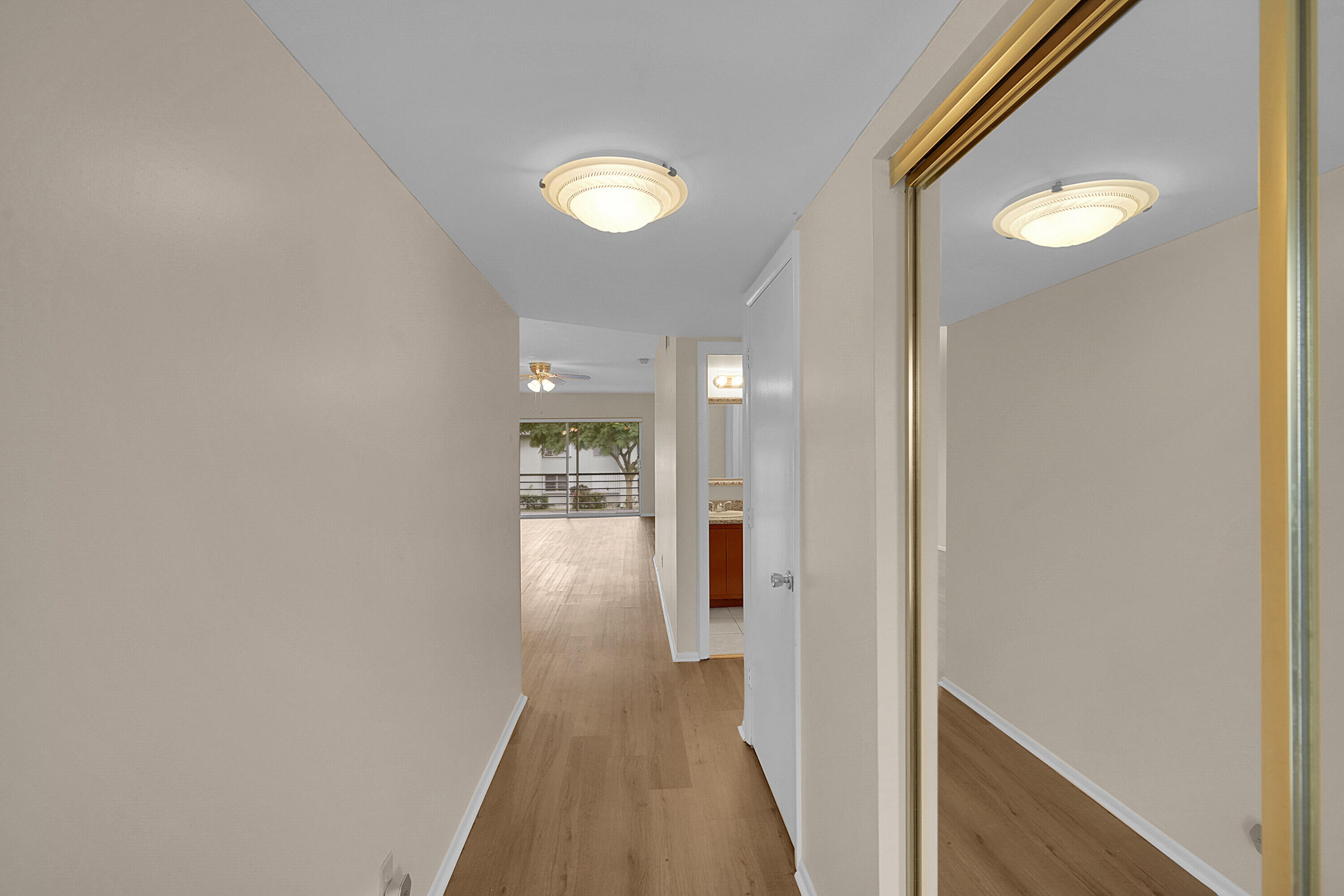 2340 Southwest 22nd Avenue, Unit 306 Delray Beach, FL 33445 - Photo 3 of 33 a view of a hallway with wooden floor