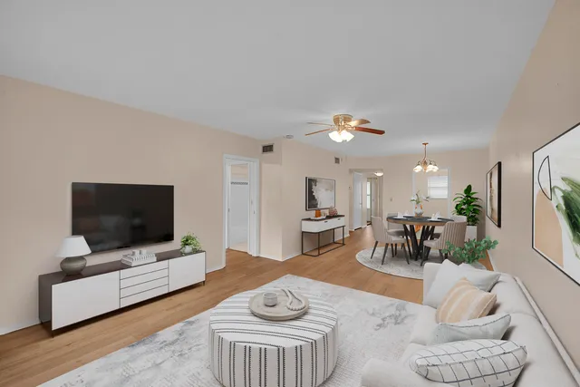 a view of a big room with wooden floor and windows