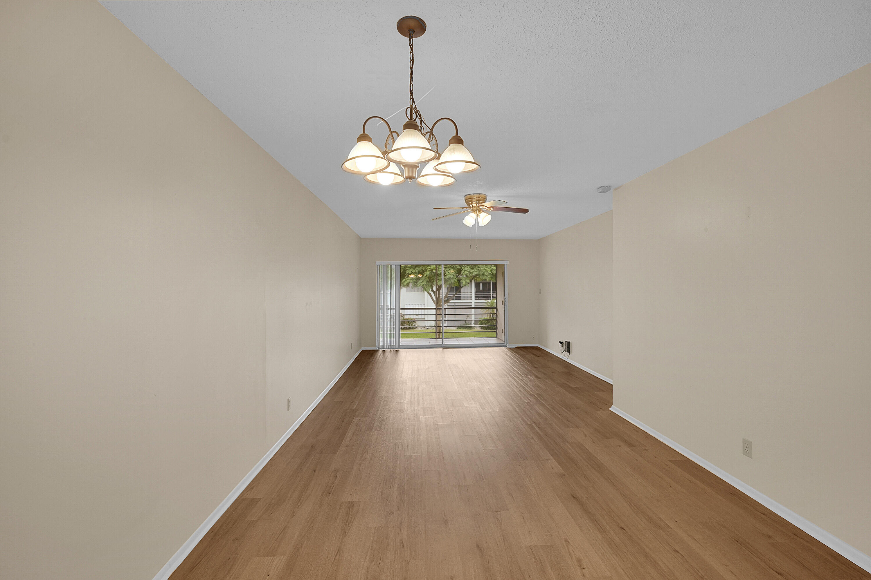 2340 Southwest 22nd Avenue, Unit 306 Delray Beach, FL 33445 - Photo 9 of 33 a view of a big room with wooden floor and a window