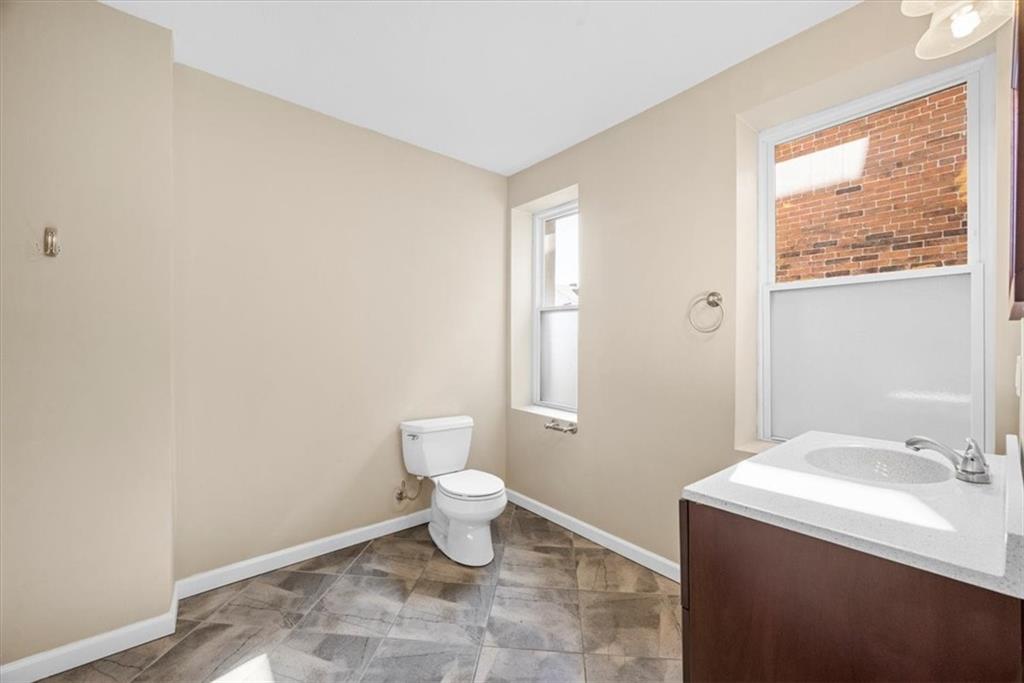 245 37th Street Pittsburgh, PA 15201 - Photo 17 of 29 a bathroom with a sink a toilet and a window