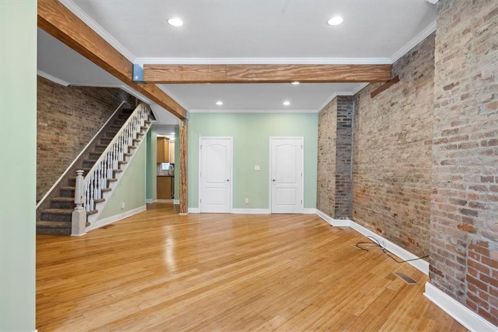 245 37th Street Pittsburgh, PA 15201 - Photo 4 of 29 a view of a hallway with wooden floor and staircase