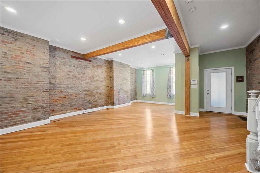245 37th Street Pittsburgh, PA 15201 - Photo 5 of 29 a view of an empty room with wooden floor and a bathroom