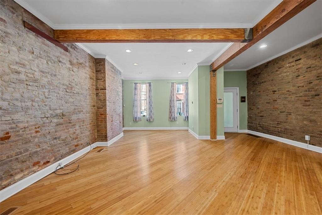 245 37th Street Pittsburgh, PA 15201 - Photo 6 of 29 a view of an empty room with wooden floor and a window