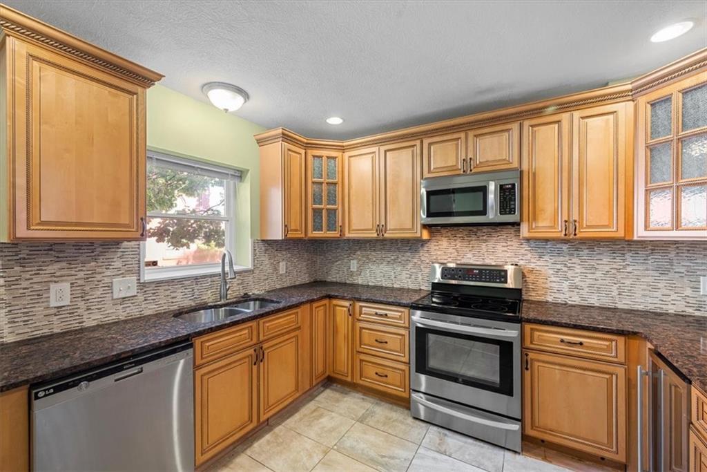245 37th Street Pittsburgh, PA 15201 - Photo 9 of 29 a kitchen with granite countertop a sink stainless steel appliances and cabinets