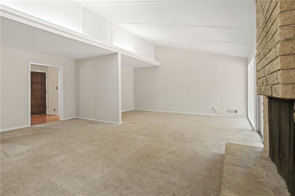 705 Edgewater Trail Sandy Springs, GA 30328 - Photo 7 of 36 an empty room with a fireplace