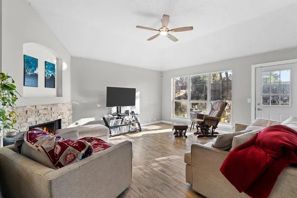 a kitchen with stainless steel appliances a dining table chairs stove refrigerator and cabinets