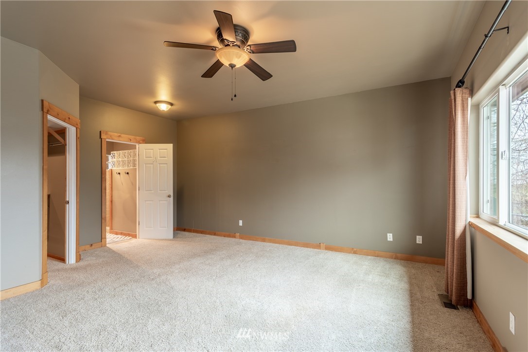2805 Squilchuck Road Wenatchee, WA 98801 - Photo 12 of 34 an empty room with chandelier fan and windows