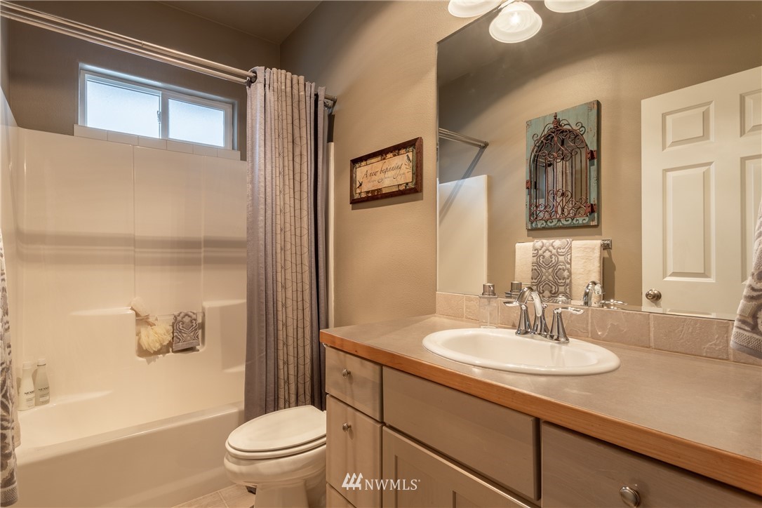 2805 Squilchuck Road Wenatchee, WA 98801 - Photo 17 of 34 a bathroom with a sink a toilet and shower curtain