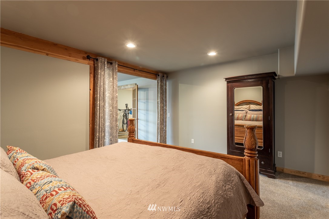 2805 Squilchuck Road Wenatchee, WA 98801 - Photo 26 of 34 a bedroom with a large bed and a wooden floor