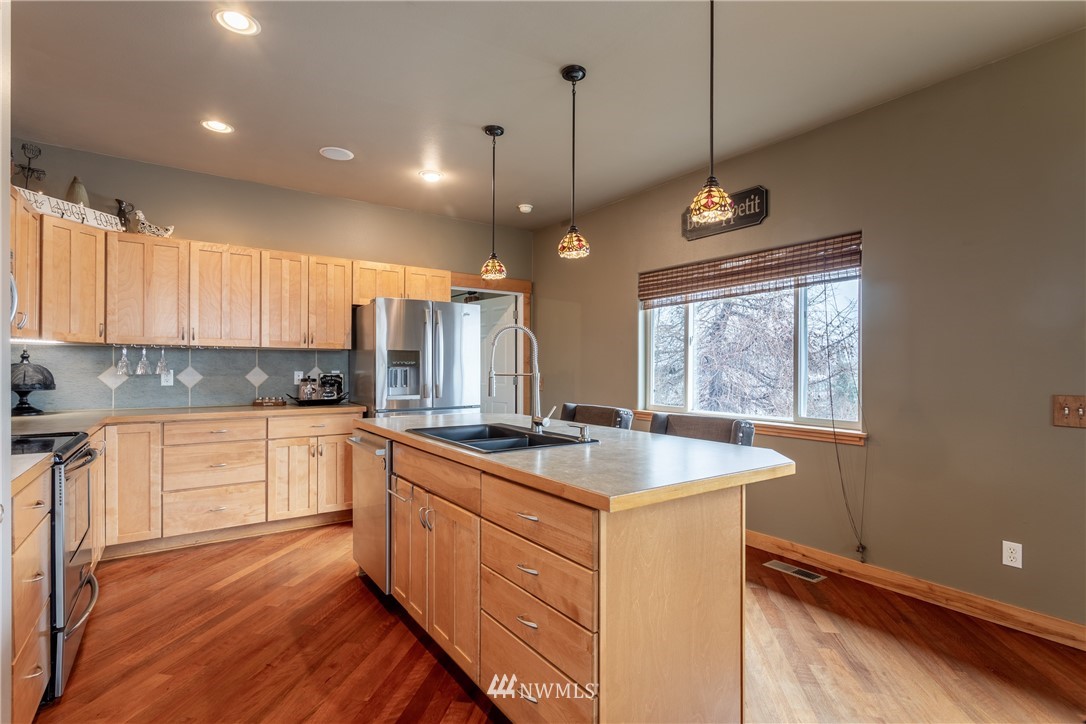 2805 Squilchuck Road Wenatchee, WA 98801 - Photo 10 of 34 a kitchen with a sink stove and cabinets