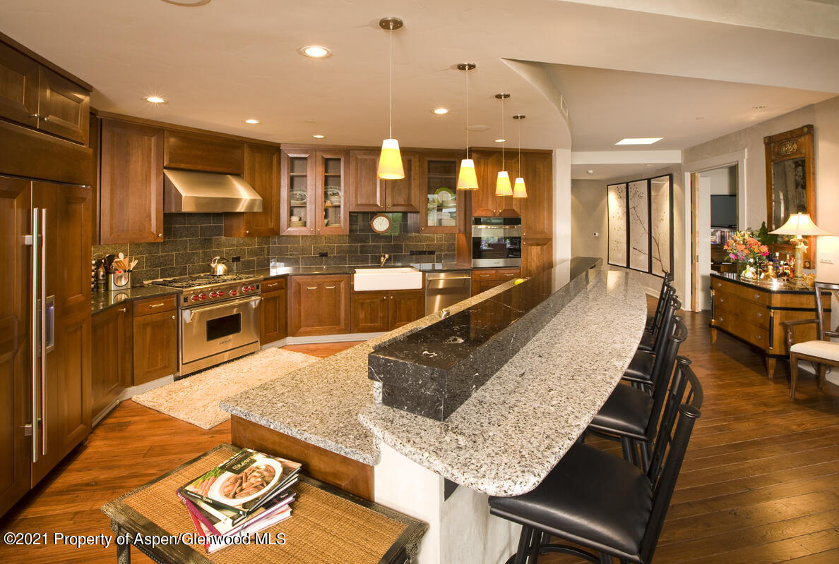 a large kitchen with stainless steel appliances lots of counter space and breakfast area