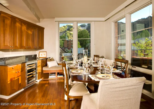a living room with fireplace furniture and a large window