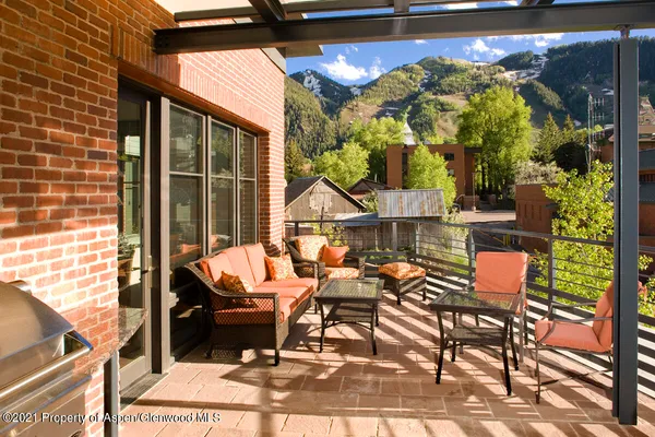 a view of a chairs and table in the balcony