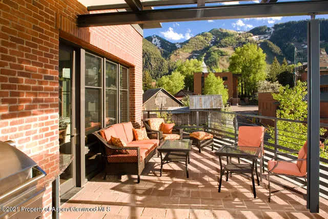 a view of a chairs and table in the balcony