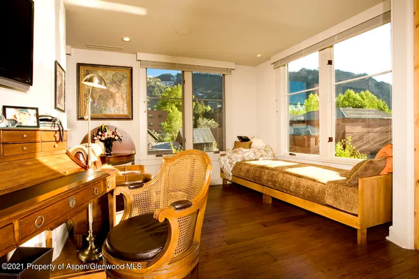 a bed room with a bed and glass door