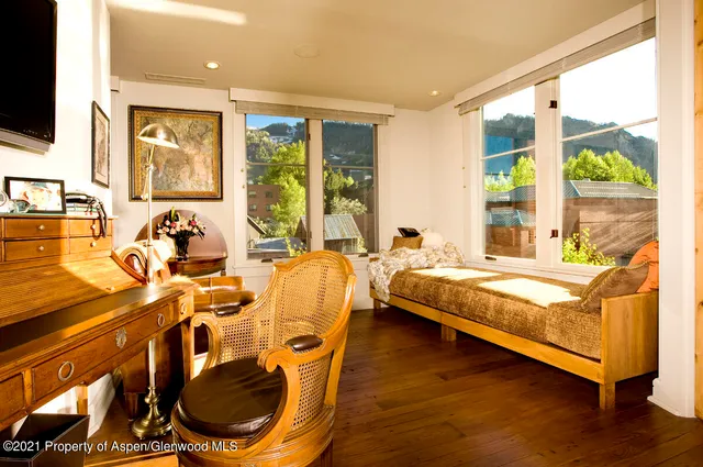 a bed room with a bed and glass door