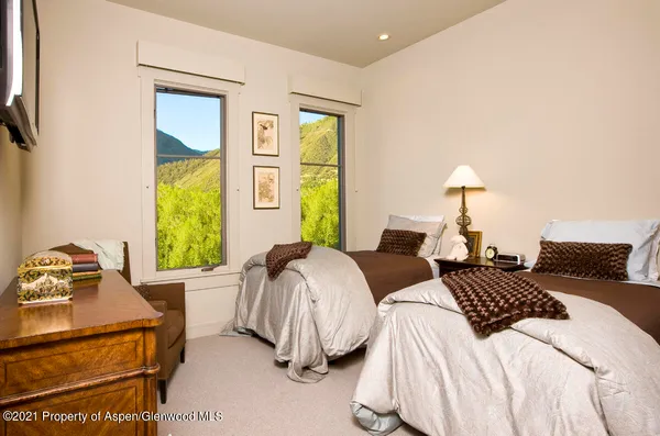 a bedroom with two beds and a window