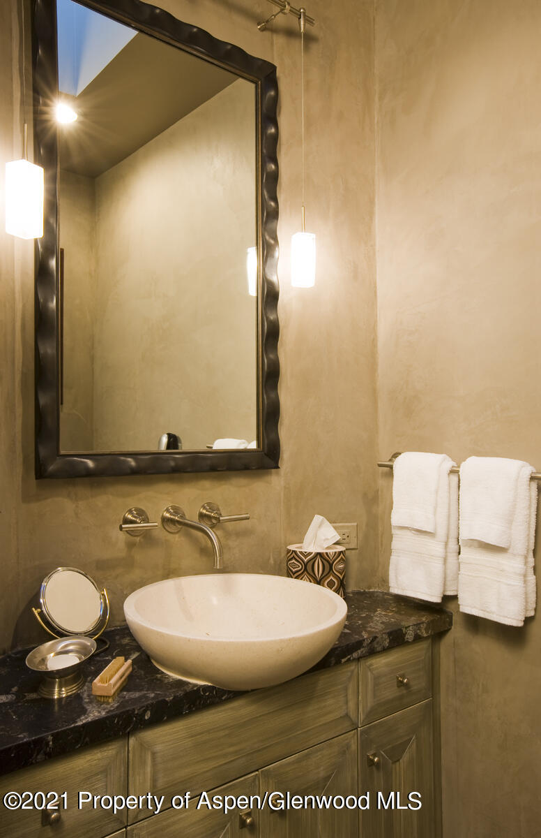 501 Rio Grande Place, Unit 206 Aspen, CO 81611 - Photo 10 of 10 a bathroom with a sink and a mirror