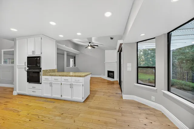 a large kitchen with stainless steel appliances granite countertop a stove and a sink