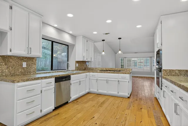 wooden floor in an empty room with a fireplace
