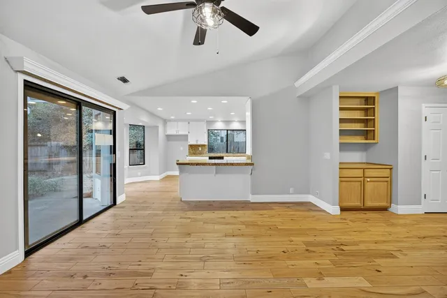 a view of a room with wooden floor and cabinet