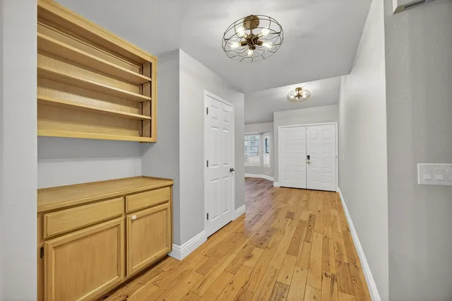 a view of a hallway with wooden floor