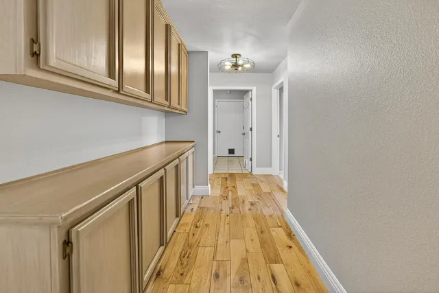 an empty room with a window and a fan