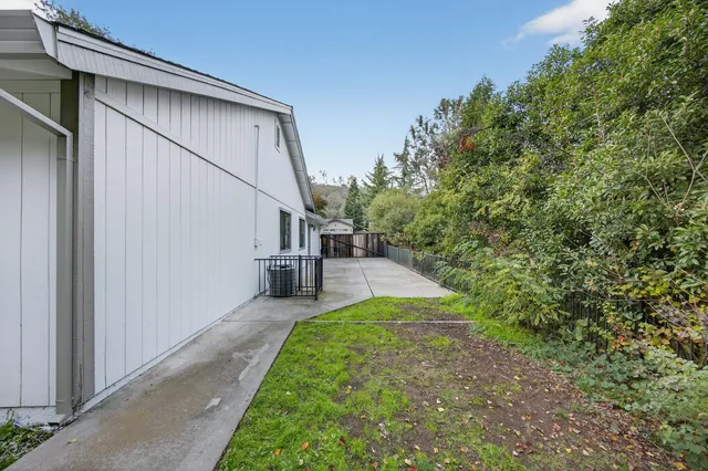 a view of house with backyard