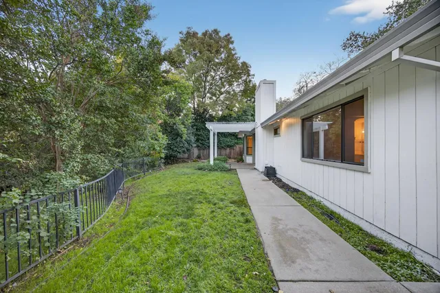 a view of a patio with table and chairs and potted plants
