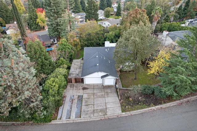 an aerial view of a house with a yard