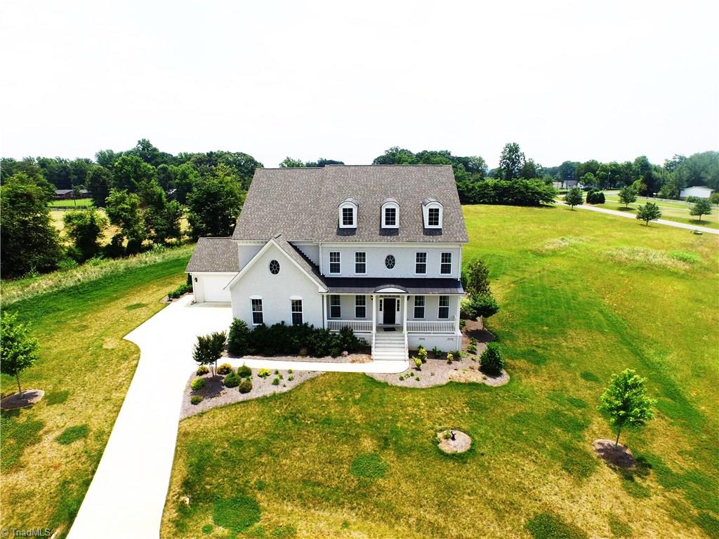 7797 Panda Court Oak Ridge, NC 27310 - Photo 2 of 23 Cul-de-sac lot, rocking chair front porch, architectural roof. Majestic, don't you think?