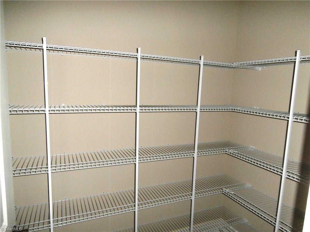 7797 Panda Court Oak Ridge, NC 27310 - Photo 11 of 23 Now this is a pantry to die for! Plenty of room here for those extra cooking pans that never seem to stack right in the kitchen cabinets.