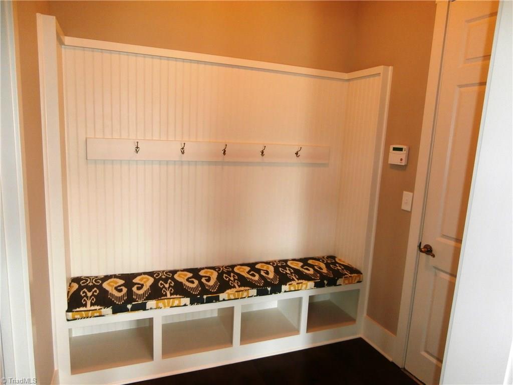 7797 Panda Court Oak Ridge, NC 27310 - Photo 14 of 23 As you enter from the garage you have a place for the kids coats and backpacks.