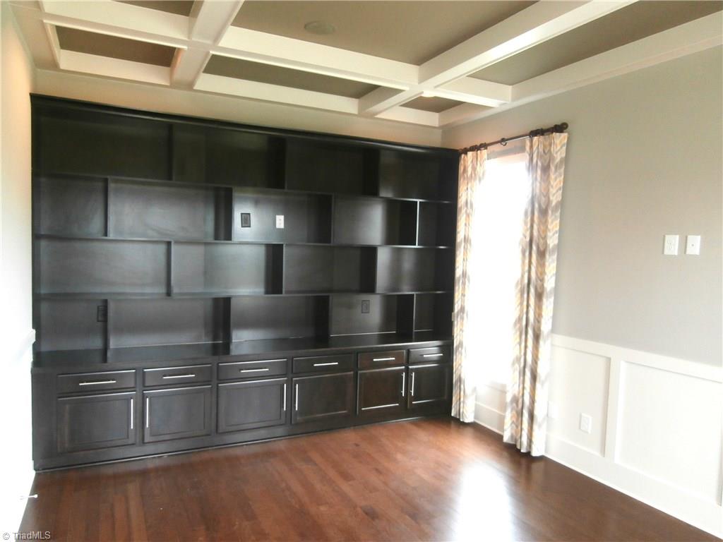 7797 Panda Court Oak Ridge, NC 27310 - Photo 17 of 23 Formal Living Room / Study with built-in shelving and cabinets. Notice the coffered ceiling.