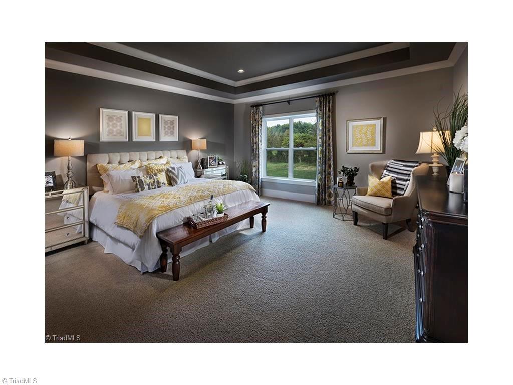7797 Panda Court Oak Ridge, NC 27310 - Photo 18 of 23 Master Bedroom has carpet that feels like walking on a cloud. Trey ceiling and recessed lighting. This photo was taken when the home was used as the model home.