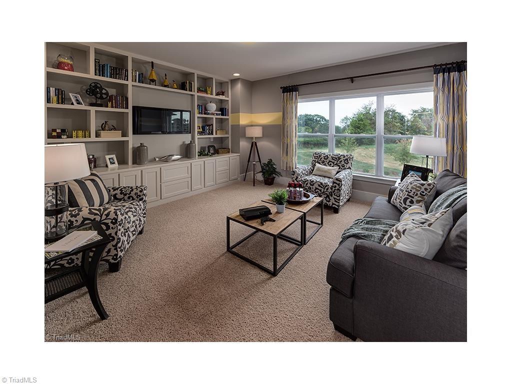 7797 Panda Court Oak Ridge, NC 27310 - Photo 21 of 23 The media room is where you will spend your evenings watching a movie or just reading a good book. This photo was taken when the home was used as the model home.