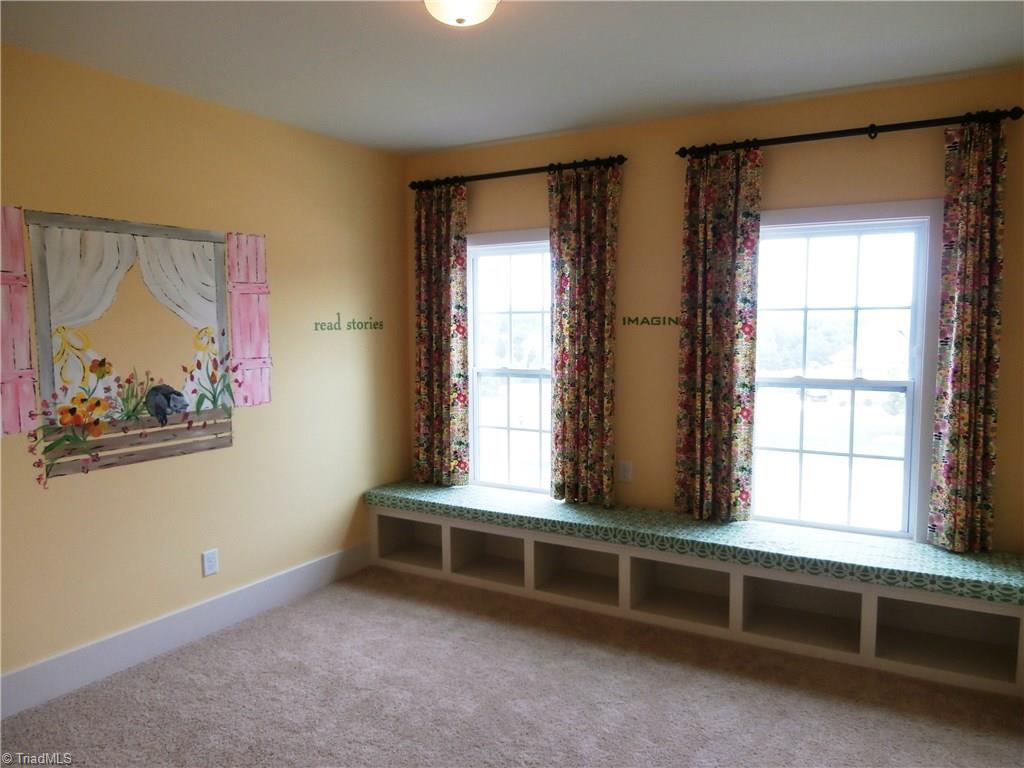 7797 Panda Court Oak Ridge, NC 27310 - Photo 22 of 23 Every home needs a kids play room. Bench seating, toy storage and murals will make this the ultimate kids hang out.