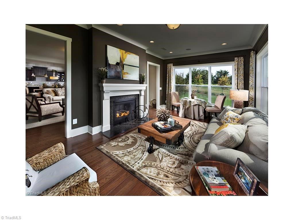 7797 Panda Court Oak Ridge, NC 27310 - Photo 5 of 23 Sunroom shares a double sided fireplace with the great room. Tons of sunlight! This photo was taken when the home was used as the model home.