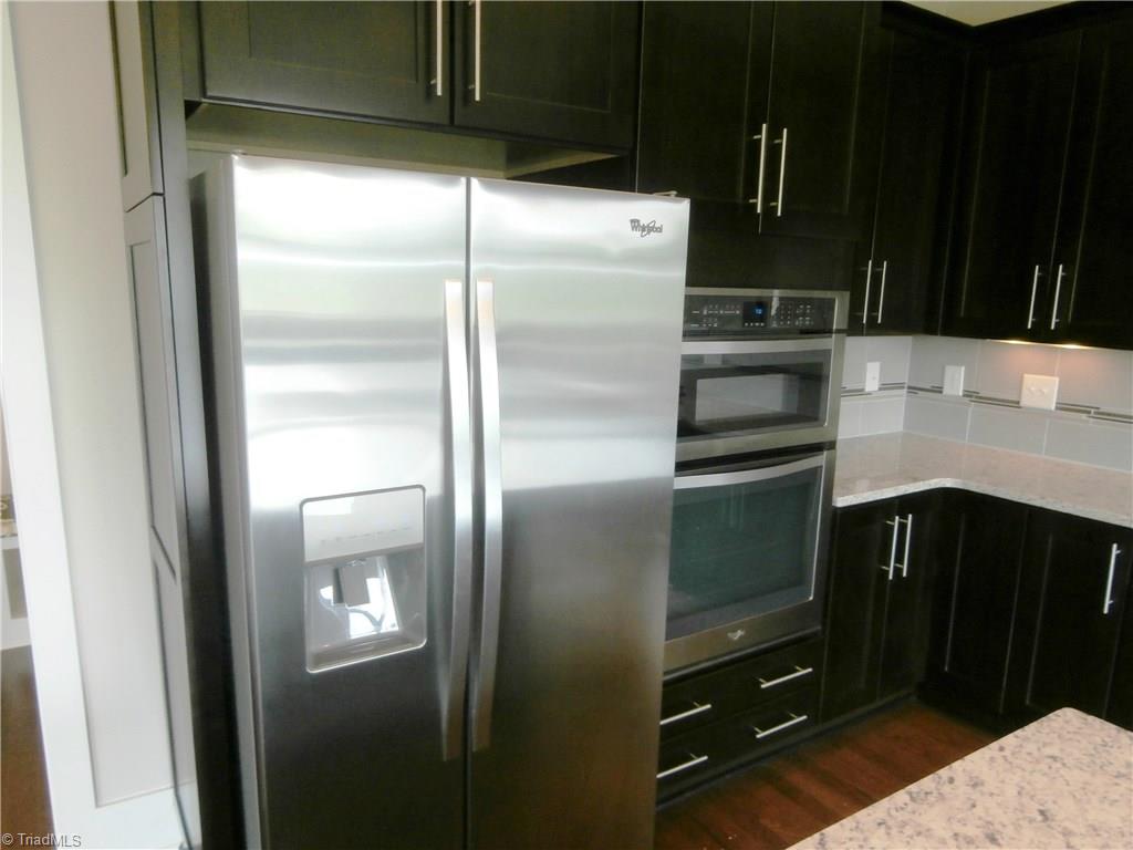 7797 Panda Court Oak Ridge, NC 27310 - Photo 9 of 23 Built-in microwave and oven. This are top of the line Whirlpool appliances.