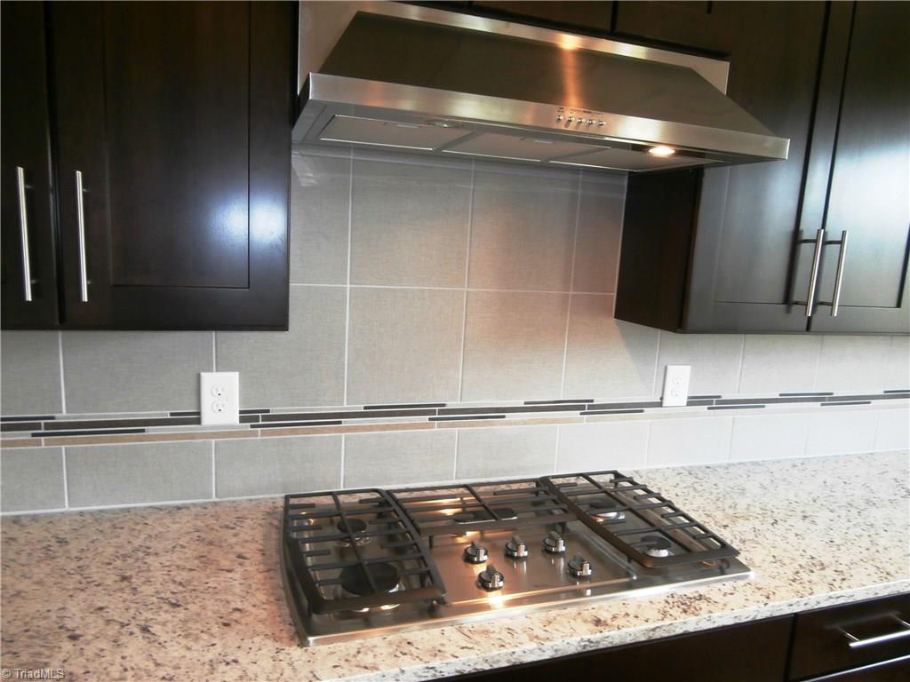 7797 Panda Court Oak Ridge, NC 27310 - Photo 10 of 23 5 burner gas cooktop. Upgraded hood is straight out of Southern Living.