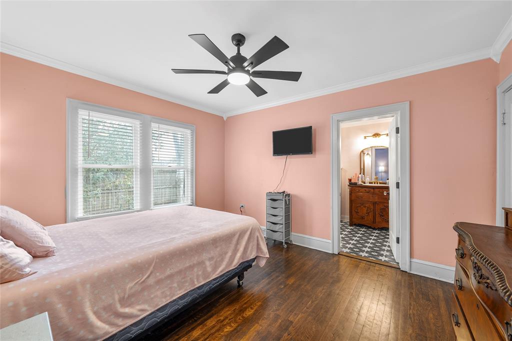 628 North 33rd Street Waco, TX 76710 - Photo 14 of 35 a bedroom with a bed and a chandelier