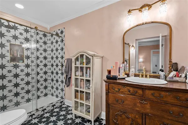 a bathroom with a sink toilet and shower