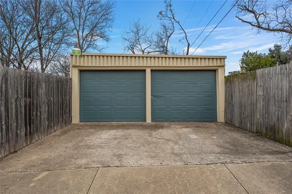 a view of backyard with wooden fence
