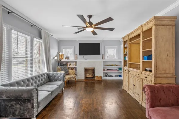 a living room with furniture a fireplace and a flat screen tv